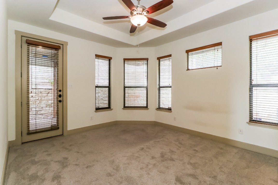 1212 Woodland Avenue, Unit A Austin, TX 78704 - Photo 10 of 20 a view of an empty room with a window and a ceiling fan