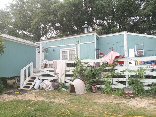 a backyard of a house with yard and outdoor seating