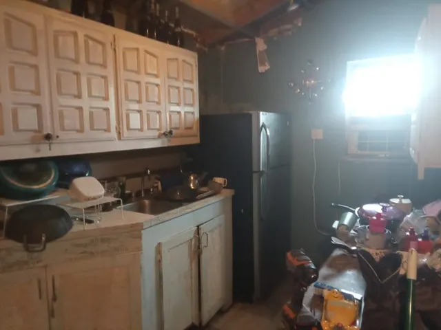 a kitchen with a sink cabinets and utility
