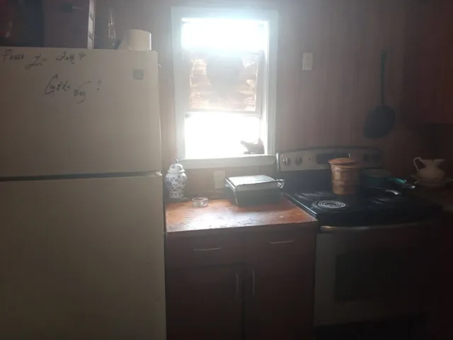 a bathroom with a sink a toilet and a window