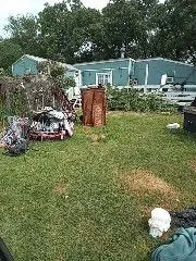 a backyard of a house with table and chairs
