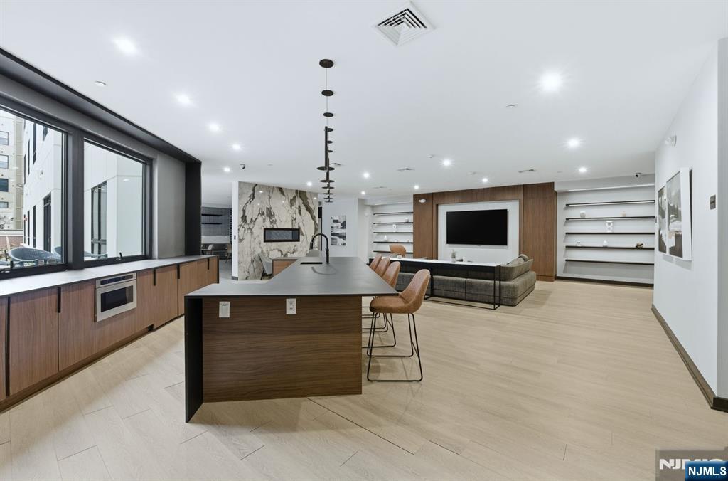 37 Orange Road, Unit 206 Montclair, NJ 07042 - Photo 12 of 16 a large kitchen with a table and chairs in it