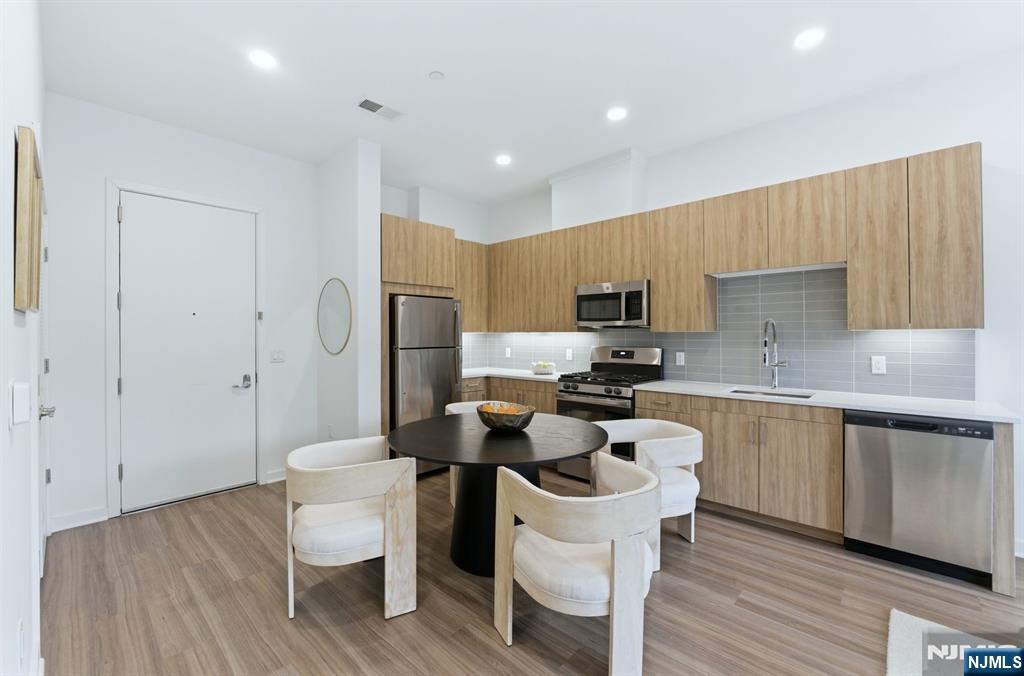 37 Orange Road, Unit 206 Montclair, NJ 07042 - Photo 4 of 16 a kitchen with a sink cabinets and wooden floor