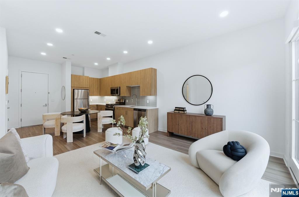 37 Orange Road, Unit 206 Montclair, NJ 07042 - Photo 5 of 16 a living room with furniture and a mirror
