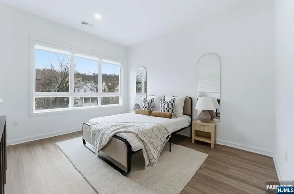 a bedroom with bed and a window