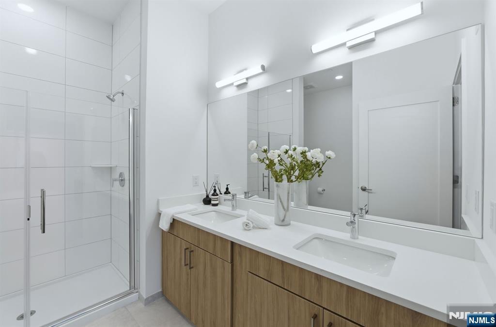 37 Orange Road, Unit 206 Montclair, NJ 07042 - Photo 7 of 16 a bathroom with a sink double vanity and a mirror
