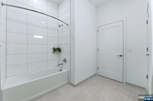 a bathroom with a bathtub and shower