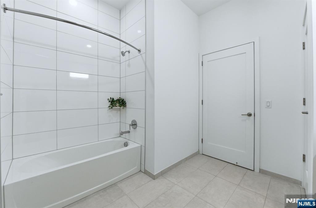 37 Orange Road, Unit 206 Montclair, NJ 07042 - Photo 10 of 16 a bathroom with a bathtub and shower