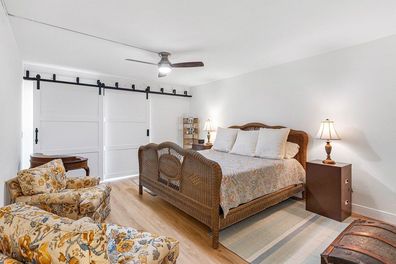 9220 Southwest 14th Street, Unit 3503 Boca Raton, FL 33428 - Photo 11 of 16 a bedroom with a bed and walk in closet