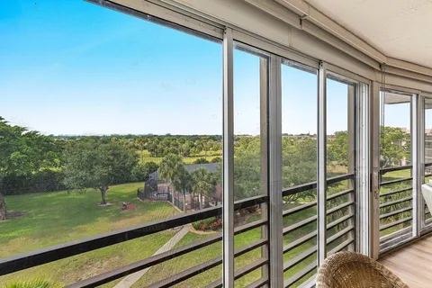 a view of a balcony with chair and a floor to ceiling window