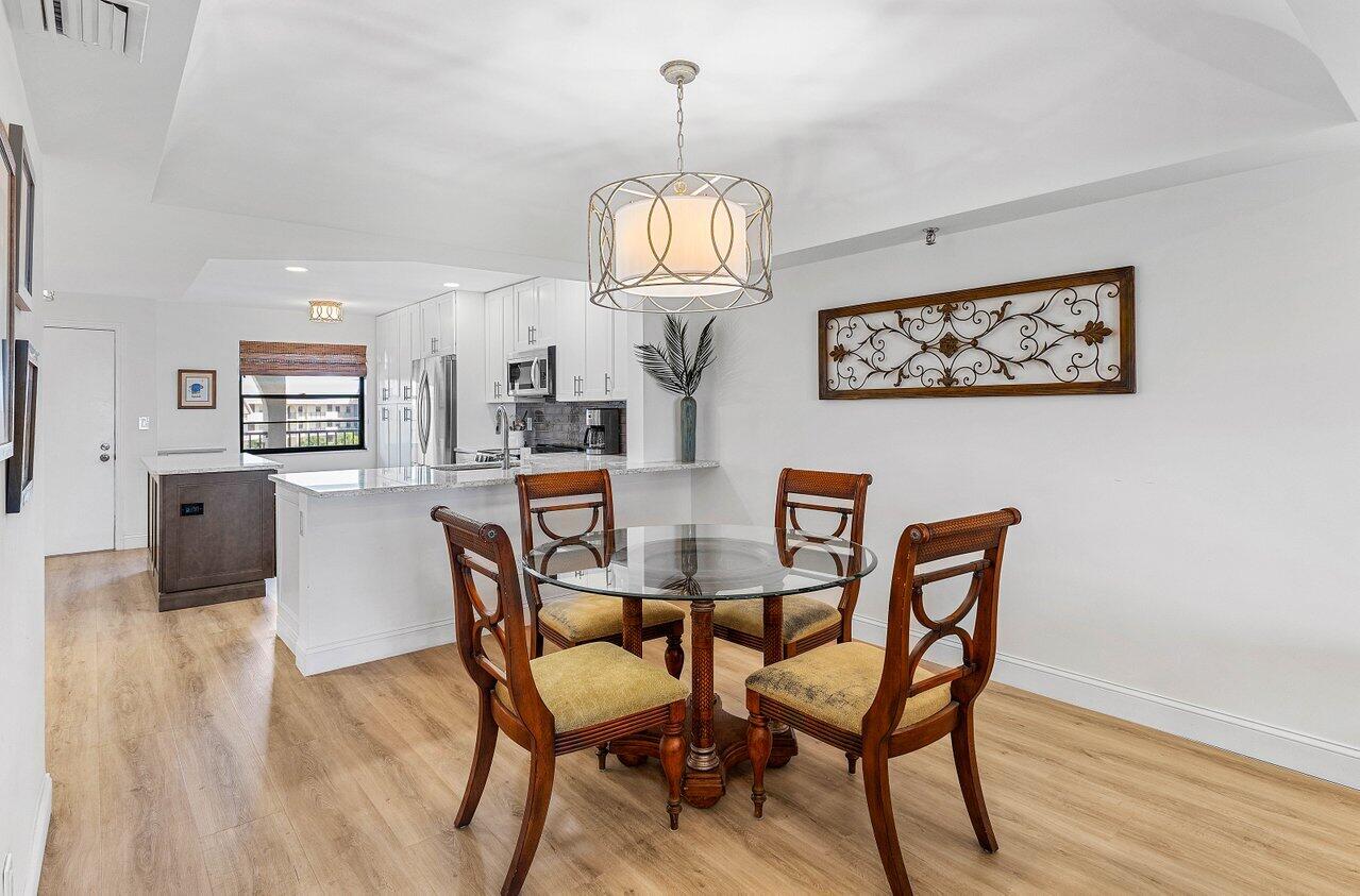 9220 Southwest 14th Street, Unit 3503 Boca Raton, FL 33428 - Photo 5 of 16 a view of a dining room with furniture and wooden floor