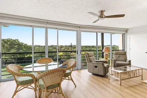 a living room with fireplace furniture and a large window