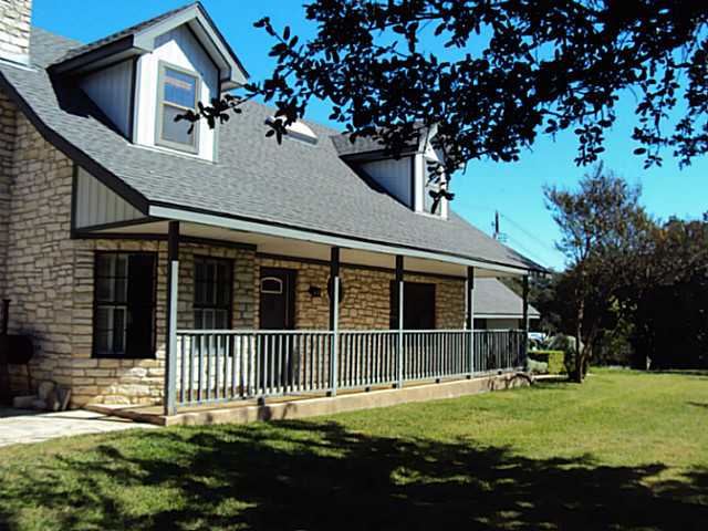 9804 Timber Ridge Pass Austin, TX 78733 - Photo 1 of 1 a front view of a house with a garden