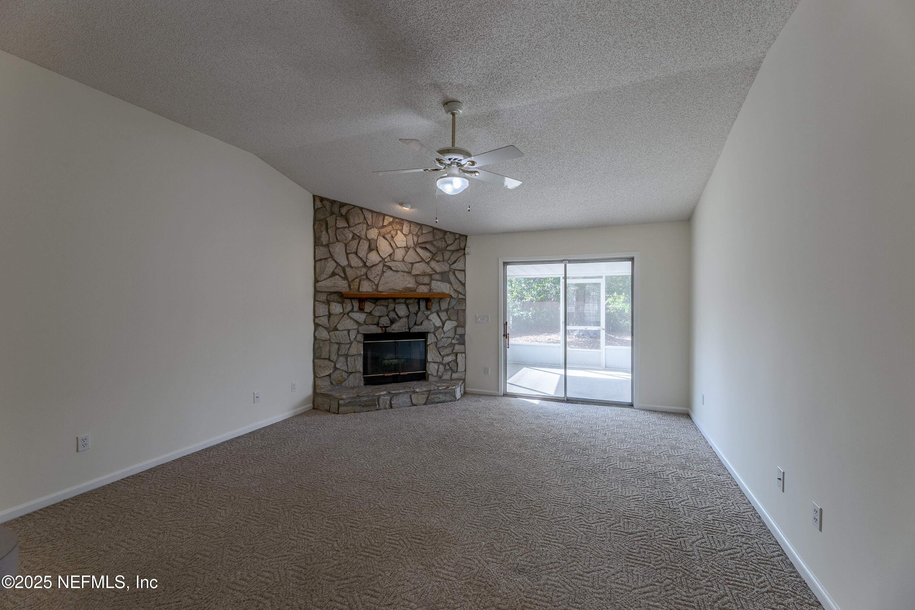 120 Clapton Way Jacksonville, FL 32220 - Photo 11 of 33 an empty room with fireplace and windows