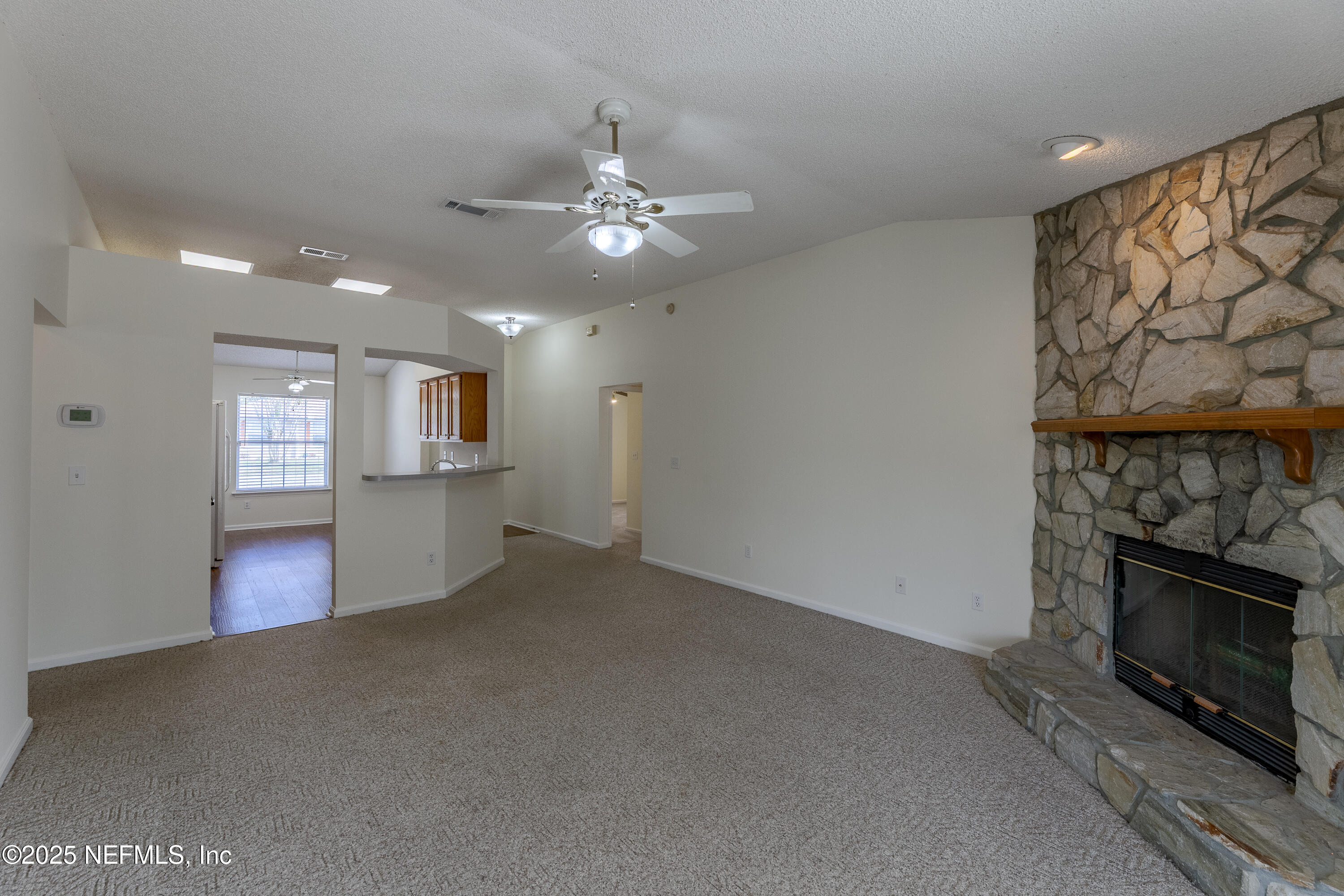 120 Clapton Way Jacksonville, FL 32220 - Photo 12 of 33 an empty room with windows and fireplace