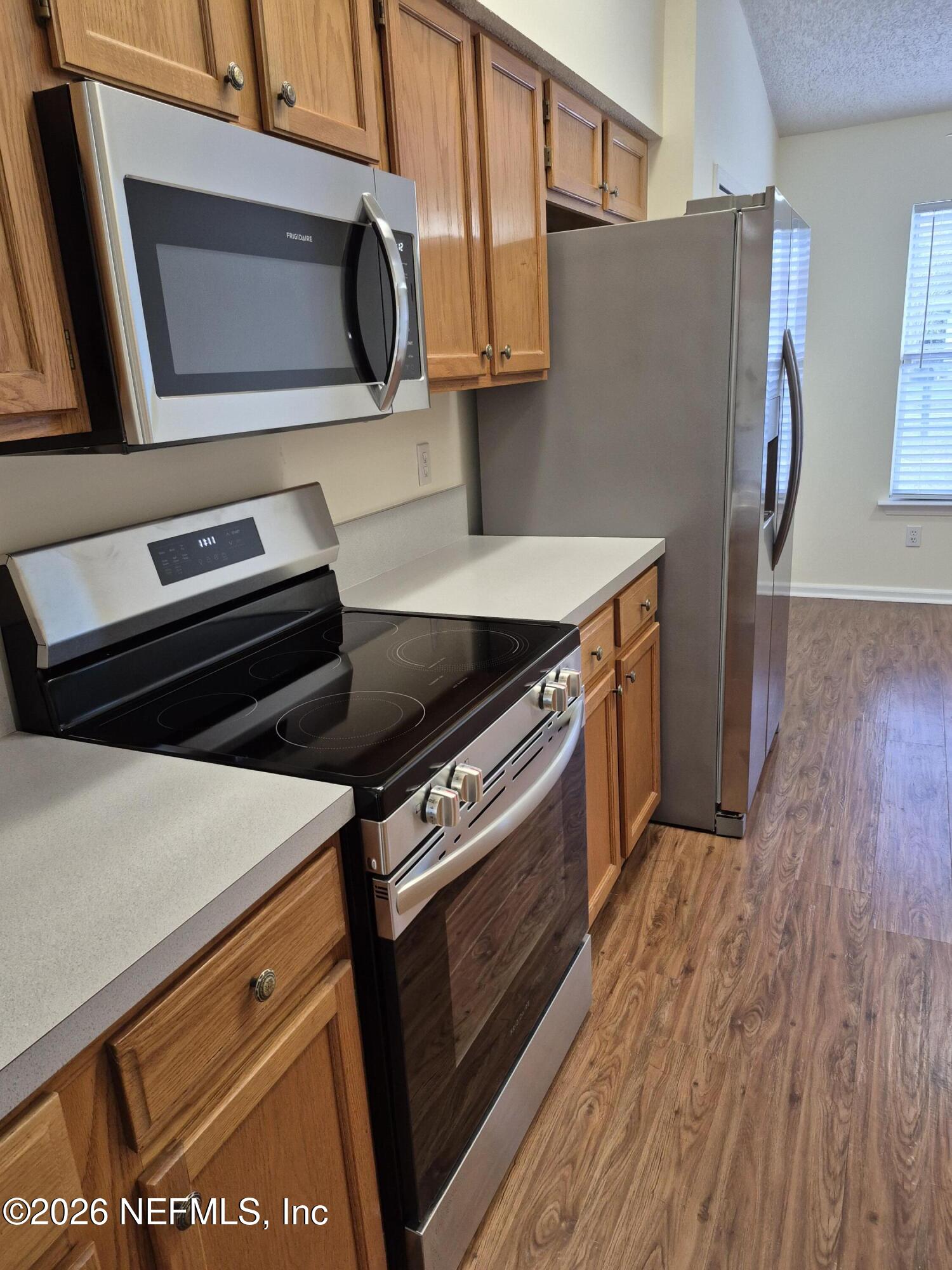 120 Clapton Way Jacksonville, FL 32220 - Photo 15 of 33 a kitchen with a stove microwave and sink