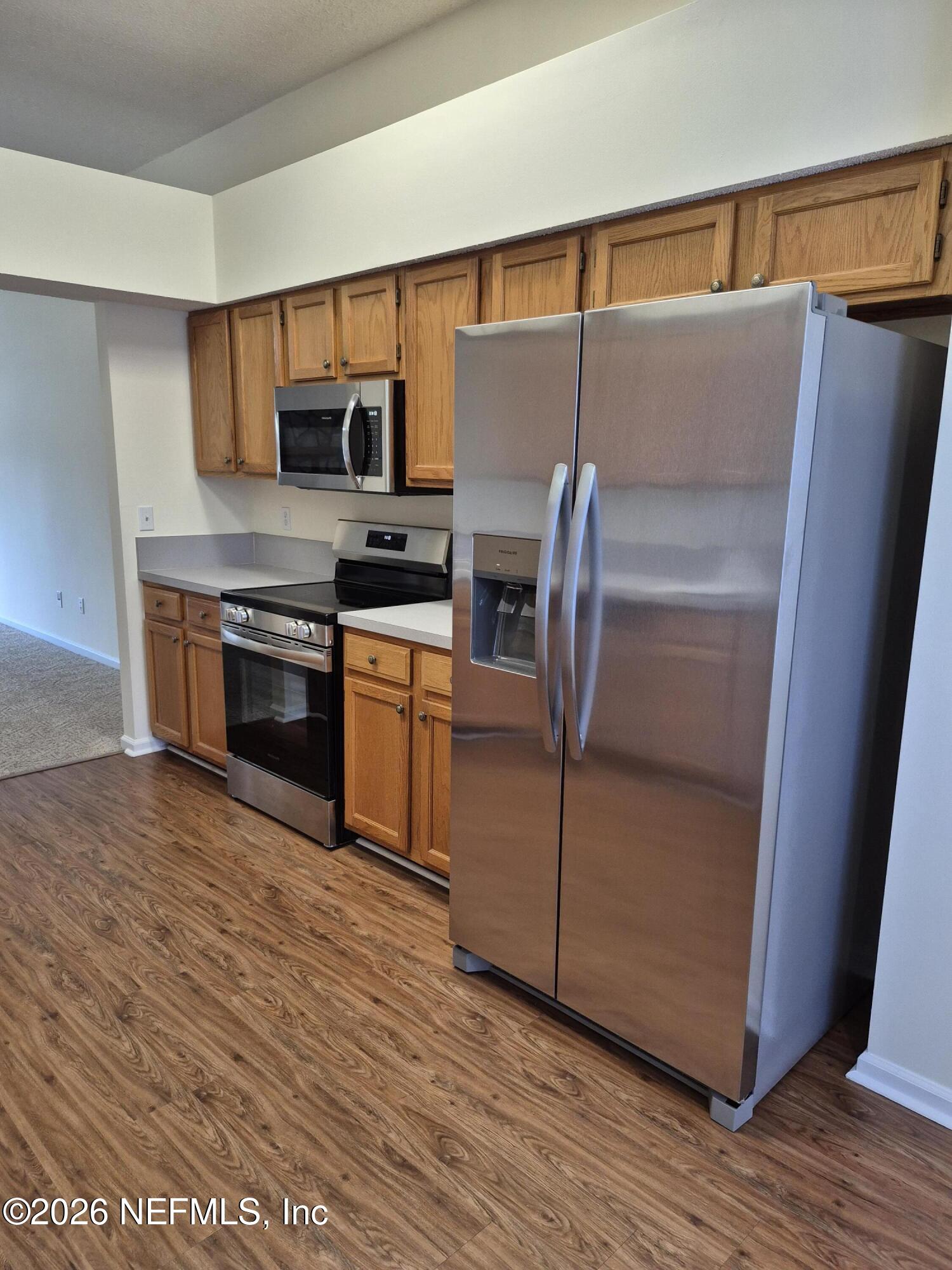 120 Clapton Way Jacksonville, FL 32220 - Photo 16 of 33 a kitchen with stainless steel appliances granite countertop a refrigerator a stove and a sink