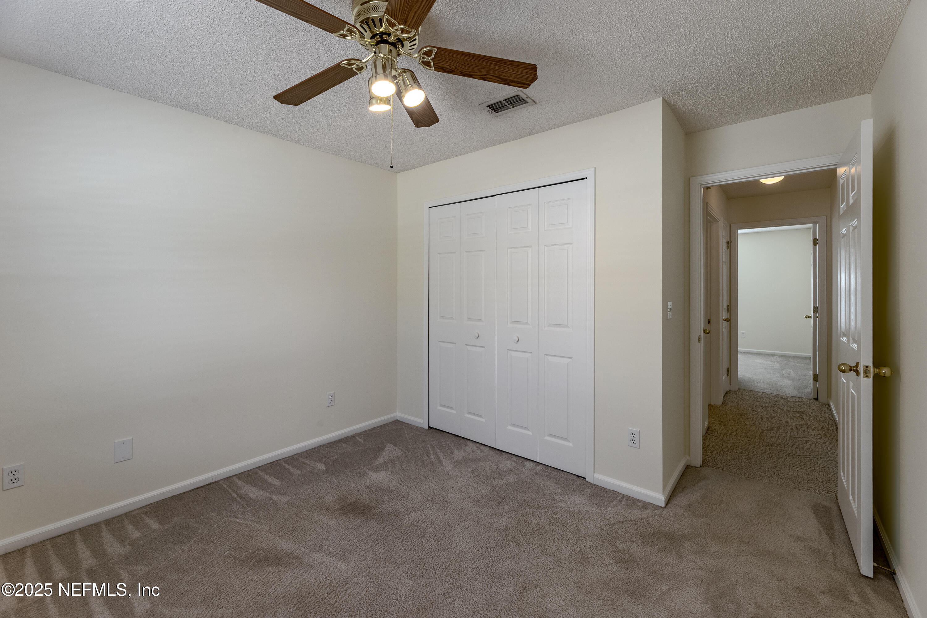120 Clapton Way Jacksonville, FL 32220 - Photo 21 of 33 an empty room with a chandelier fan and closet area