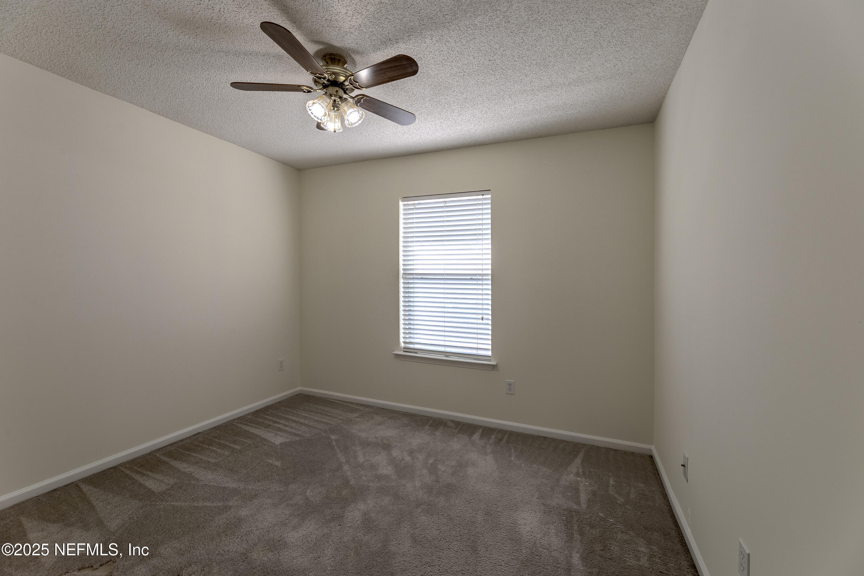 120 Clapton Way Jacksonville, FL 32220 - Photo 23 of 33 an empty room with a window and a ceiling fan