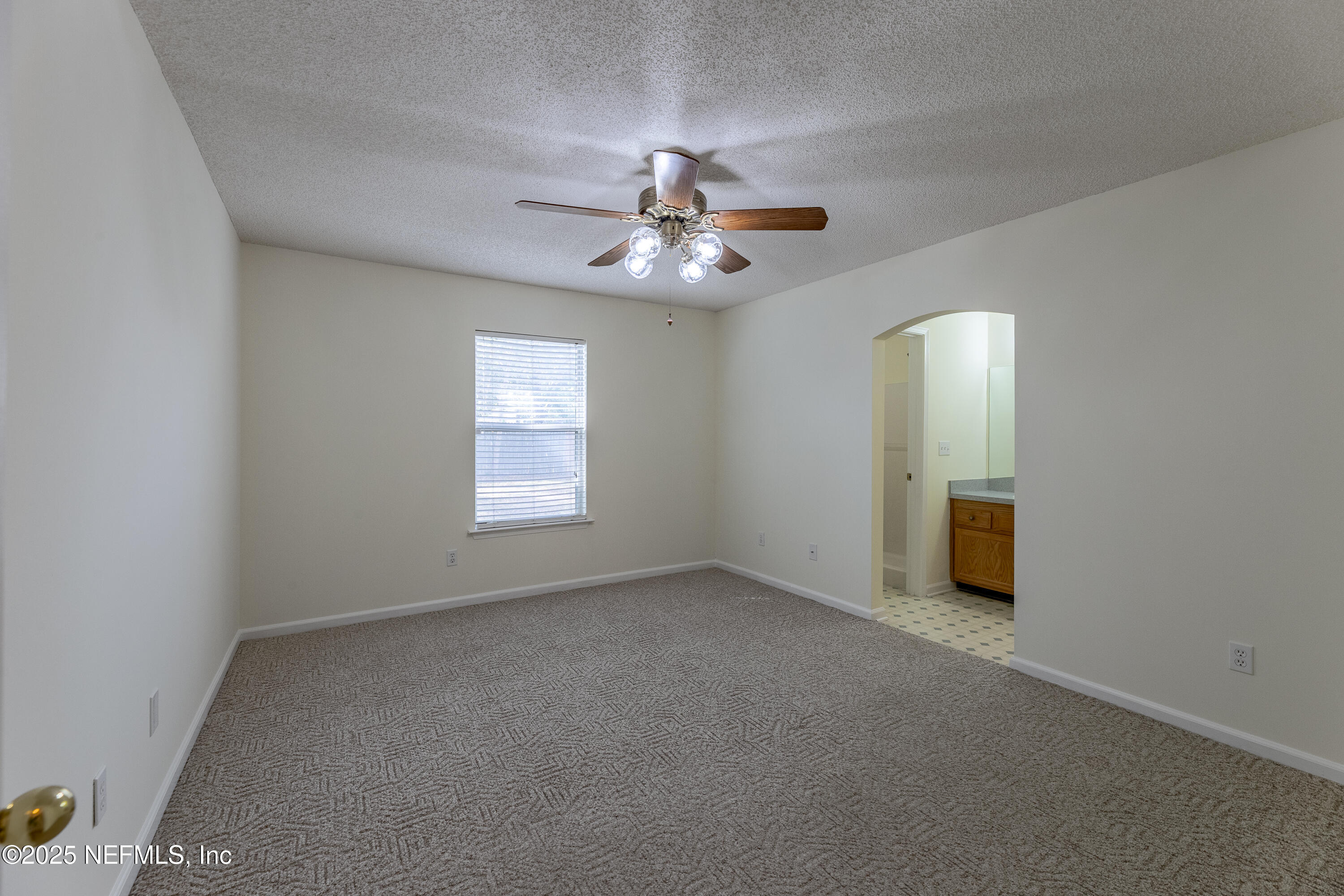 120 Clapton Way Jacksonville, FL 32220 - Photo 25 of 33 an empty room with a chandelier fan and windows