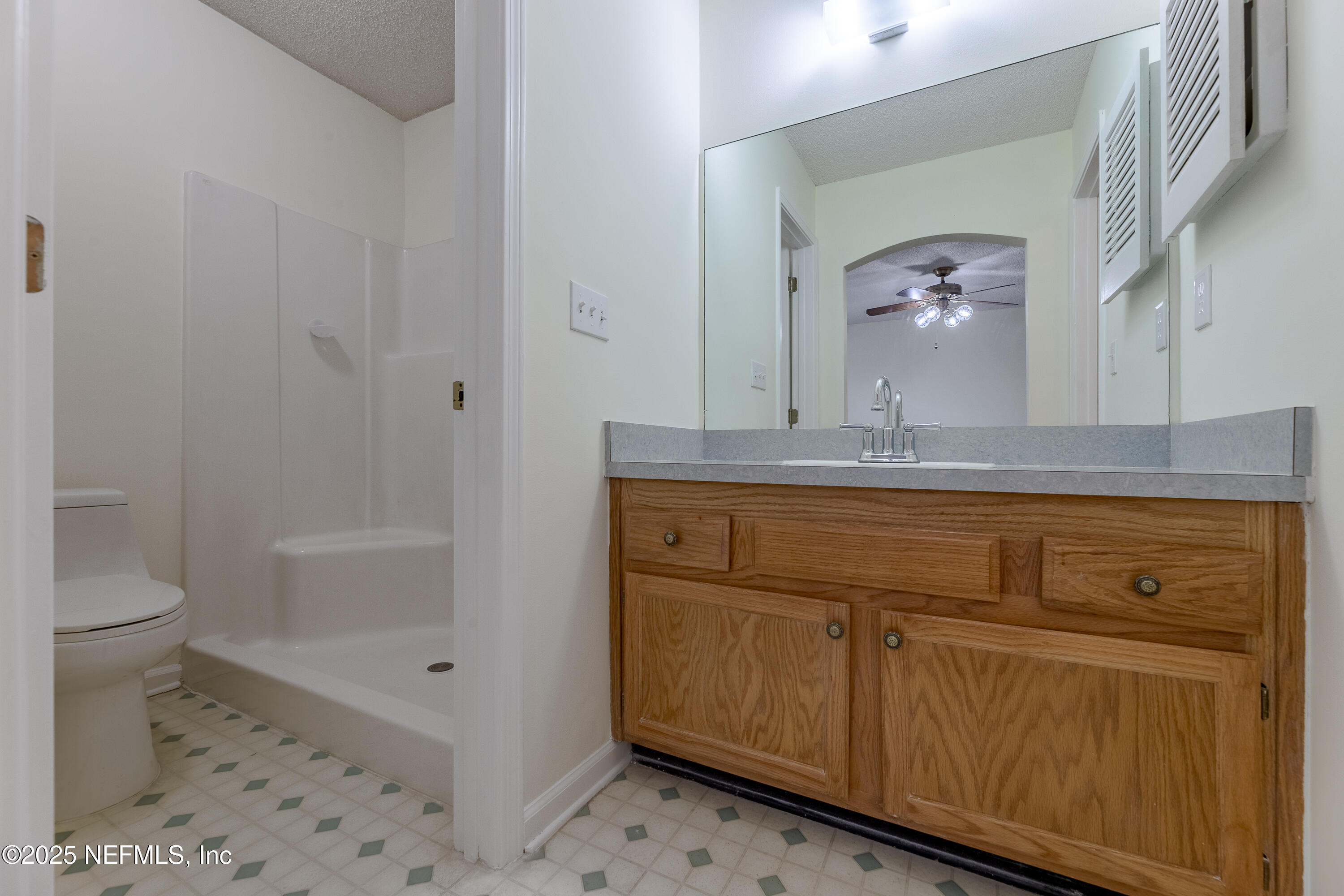 120 Clapton Way Jacksonville, FL 32220 - Photo 28 of 33 a bathroom with a granite countertop sink a toilet and shower