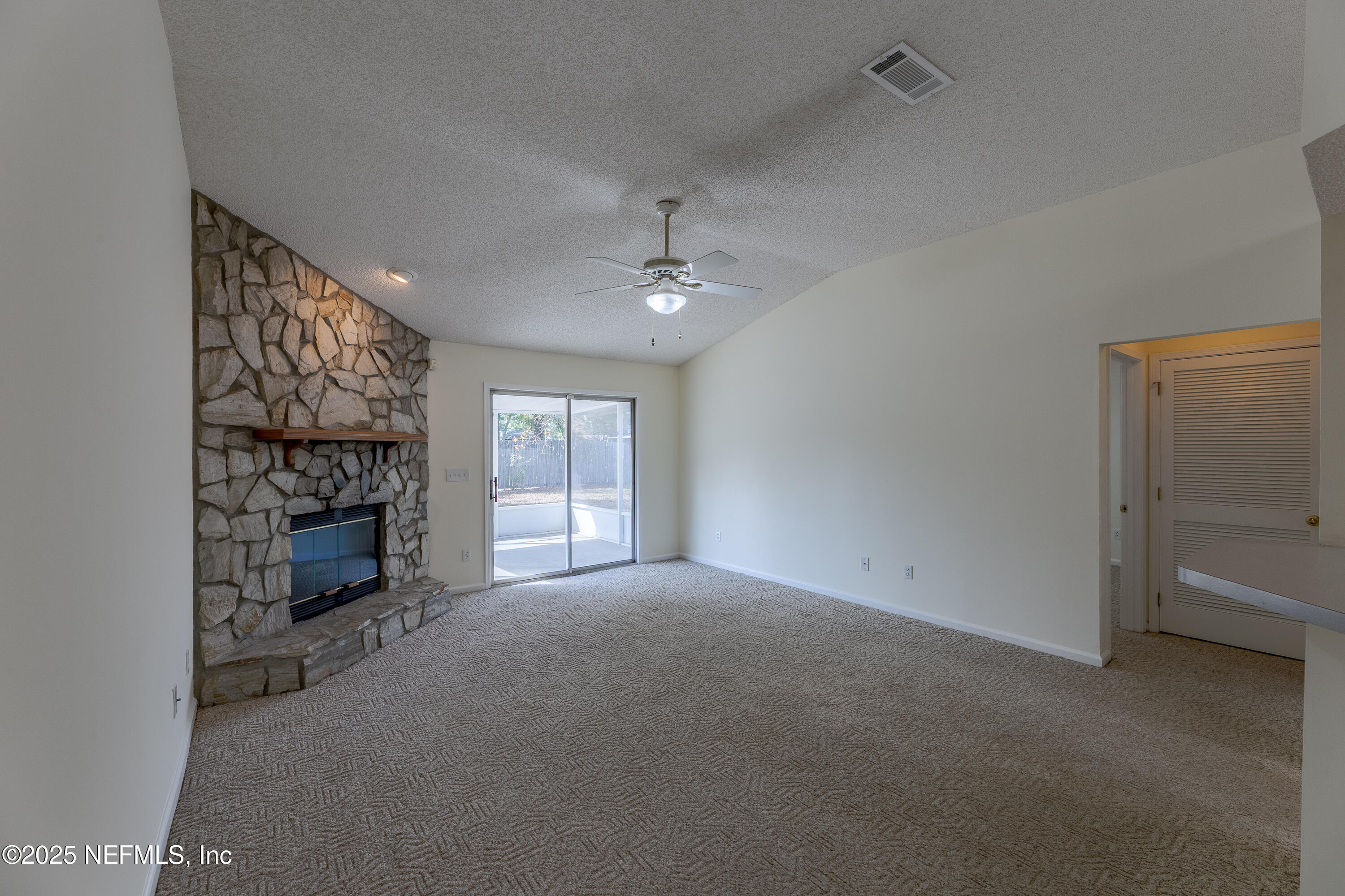 120 Clapton Way Jacksonville, FL 32220 - Photo 10 of 33 a view of an empty room with a fireplace and a window