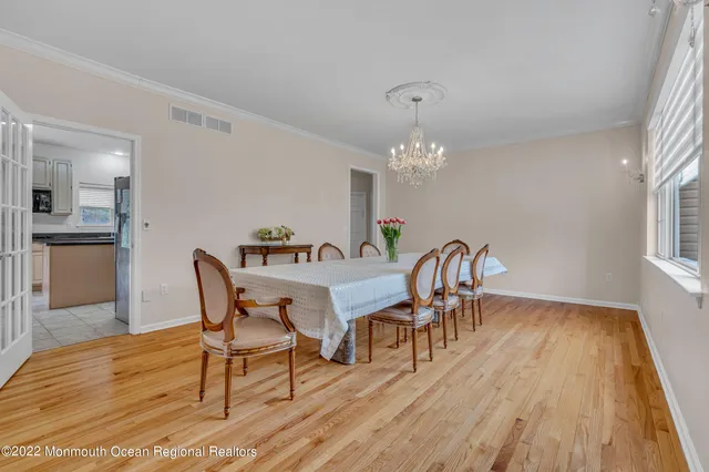 a view of a dining room with furniture and chandelier