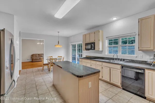 a kitchen with stainless steel appliances granite countertop a sink and dishwasher a stove top oven with wooden floor
