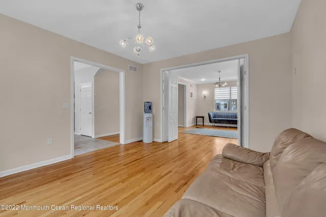 a living room with furniture rug and wooden floor