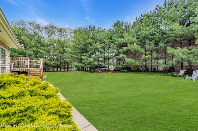 a view of balcony with chairs and wooden fence