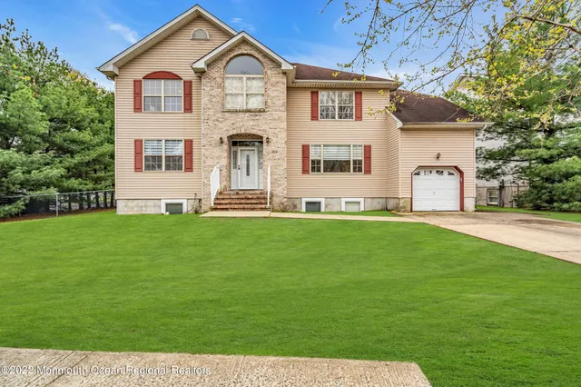 a dining room with furniture a chandelier and wooden floor