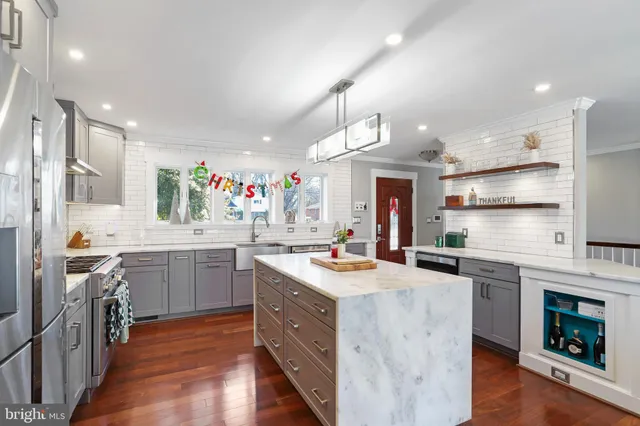 a living room with furniture stairs and a large window