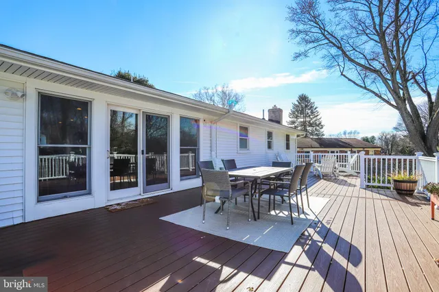 a view of a roof deck with table and chairs floor to ceiling window with wooden floor