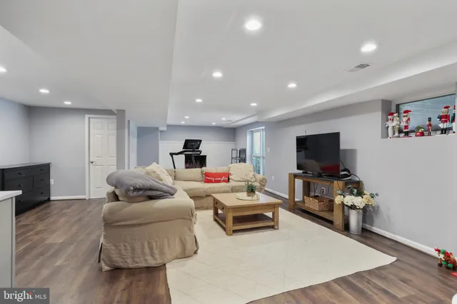 a room with gym equipment and wooden floor