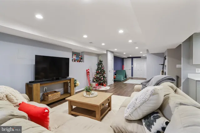 a living room with a baby crib and a couch