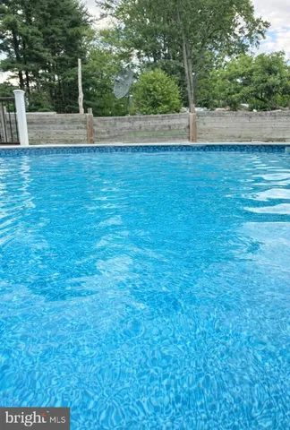 a view of a yard with wooden fence