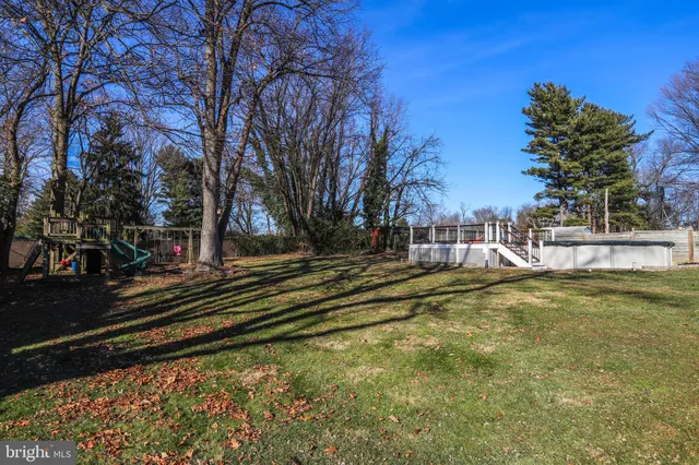a kitchen with kitchen island granite countertop a sink stove and wooden cabinets