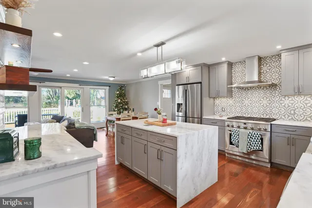 a kitchen with granite countertop a sink stainless steel appliances and cabinets
