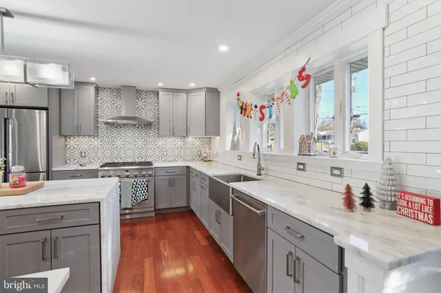 a kitchen with a stove a sink and a refrigerator