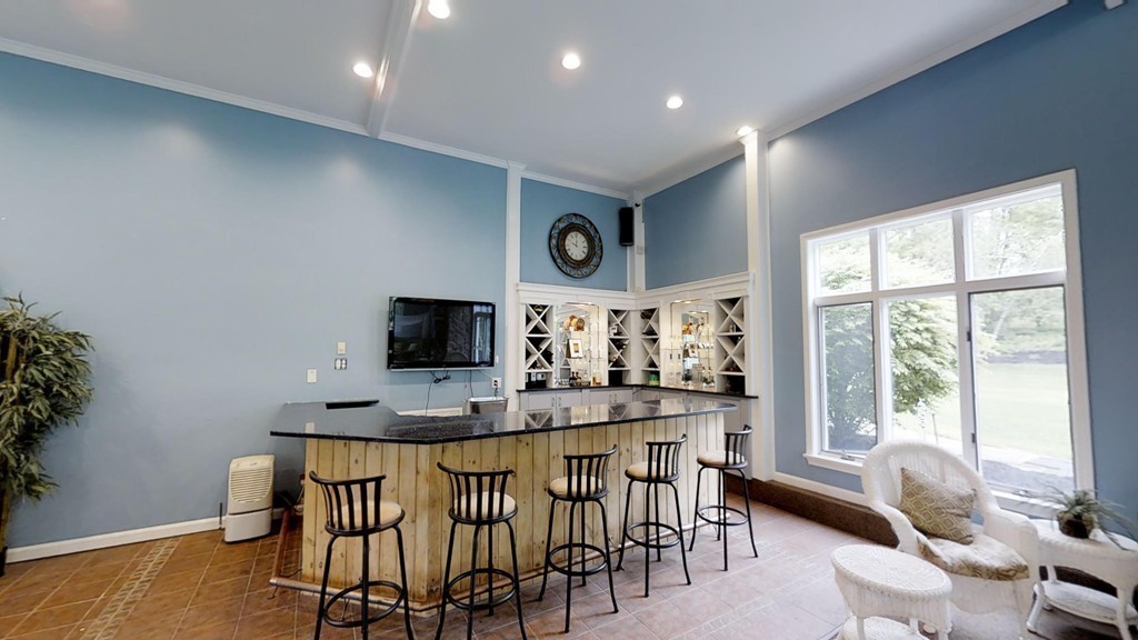 245 Haggetts Pond Road Andover, MA 01810 - Photo 14 of 30 a room with stainless steel appliances kitchen island granite countertop furniture and a large window