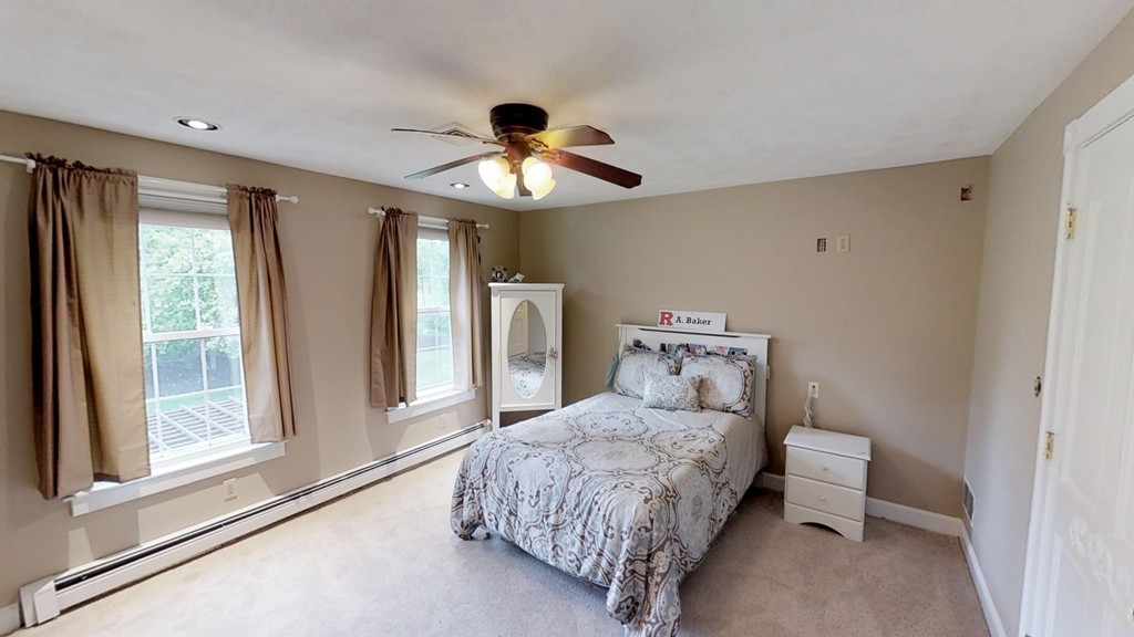 245 Haggetts Pond Road Andover, MA 01810 - Photo 18 of 30 a bedroom with a bed and a chandelier