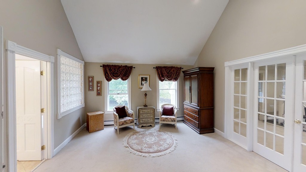 245 Haggetts Pond Road Andover, MA 01810 - Photo 21 of 30 a living room with furniture a large window and chairs