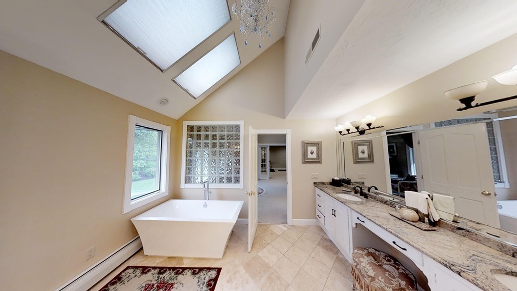 245 Haggetts Pond Road Andover, MA 01810 - Photo 22 of 30 a spacious bathroom with a large mirror vanity and bathtub