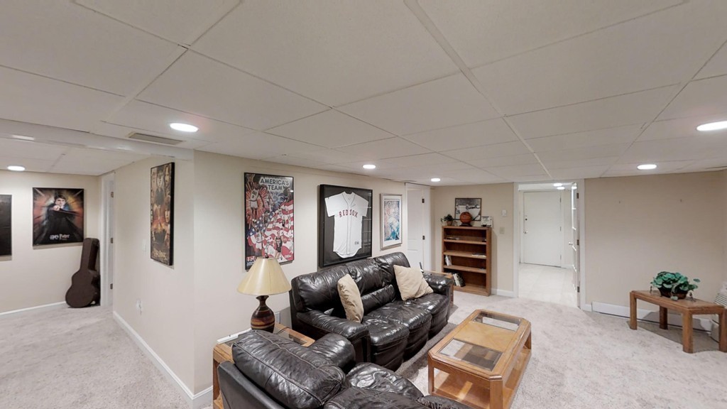 245 Haggetts Pond Road Andover, MA 01810 - Photo 25 of 30 a living room with furniture and a flat screen tv