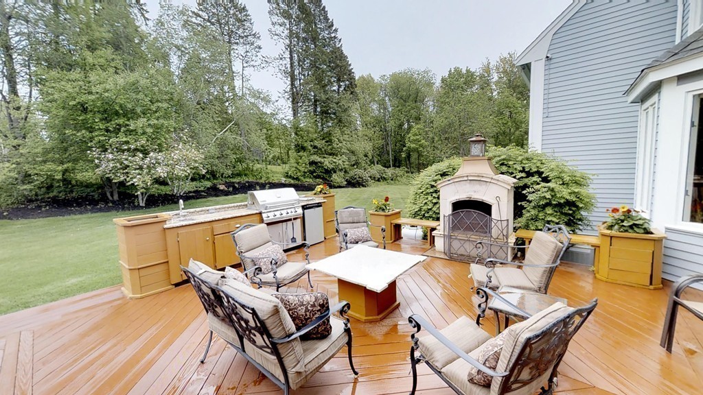 245 Haggetts Pond Road Andover, MA 01810 - Photo 28 of 30 a view of a patio with table and chairs with wooden floor and fence