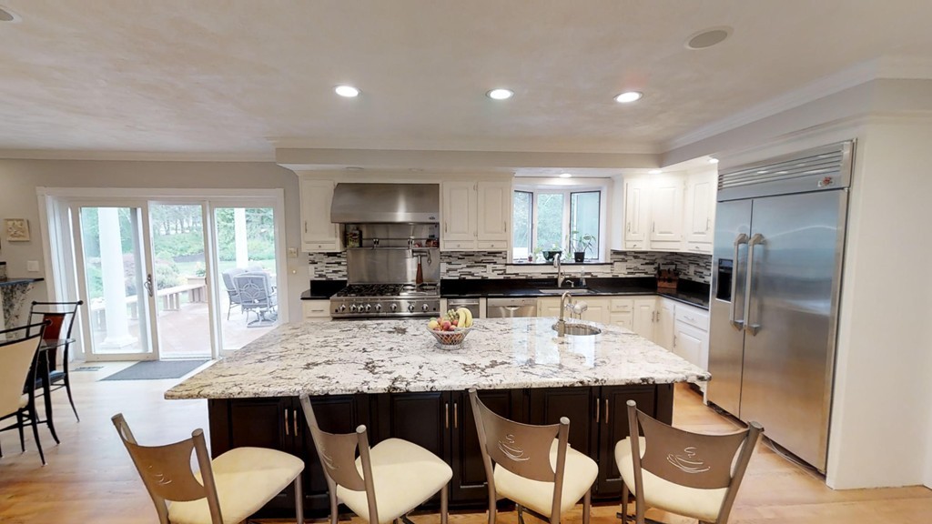 245 Haggetts Pond Road Andover, MA 01810 - Photo 3 of 30 a kitchen with a dining table chairs and refrigerator