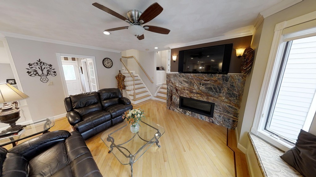 245 Haggetts Pond Road Andover, MA 01810 - Photo 5 of 30 a living room with furniture and a fireplace