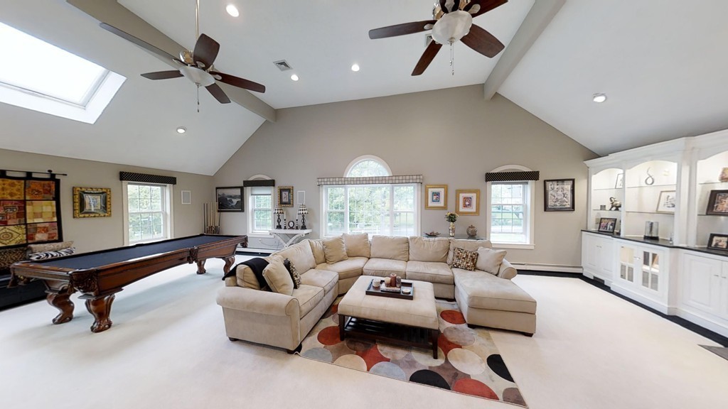 245 Haggetts Pond Road Andover, MA 01810 - Photo 8 of 30 a living room with furniture gym equipment and a large window