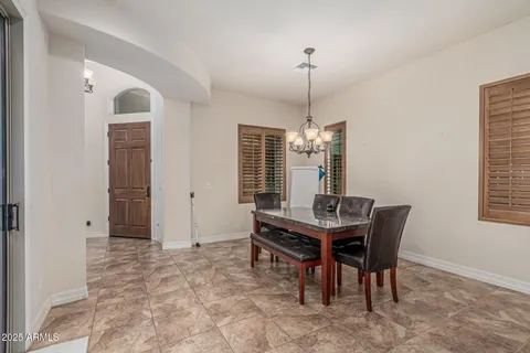 a view of a patio with a table chairs and a backyard