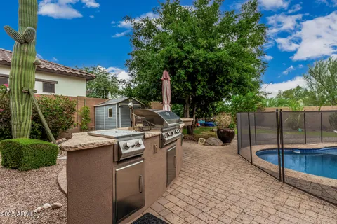 a view of a patio with a dining table and chairs